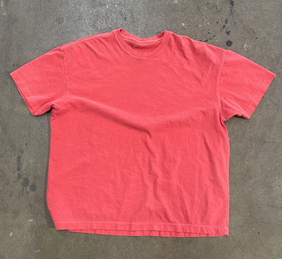 a red shirt on a concrete surface